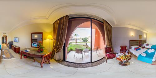 a living room with a large archway and a living room at Pickalbatros Aqua Fun Club All Inclusive in Marrakech