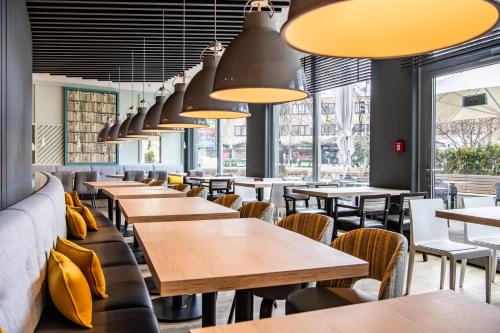 a row of tables and chairs in a restaurant at Premier Inn München Messe in Haar