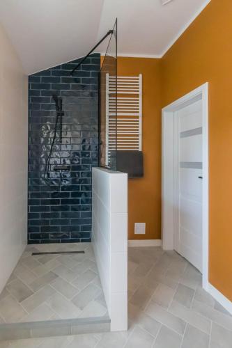 a room with a brick wall and a white door at Siedlisko Pili Pili in Sorkwity