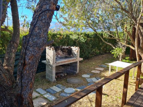 a fire pit in a yard next to a tree at Villa Tarentaal in Tulbagh