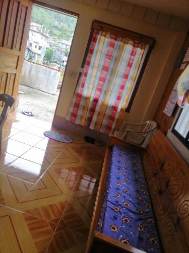 an open door with a mat in front of a room at Inn Maugay Bed and Bath in Sagada