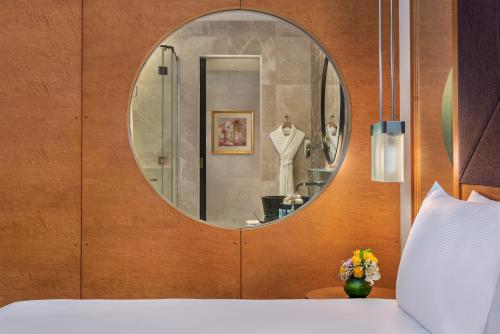 a dressing room with a mirror and a bed at Al Raha Beach Resort & Spa in Abu Dhabi