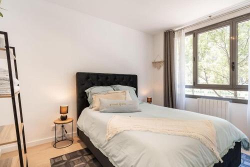 a bedroom with a bed with a large window at "Le petit bonlieu" au centre ville et à 500m du lac in Annecy
