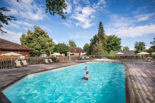 a person swimming in a swimming pool at CityKamp Colmar in Horbourg