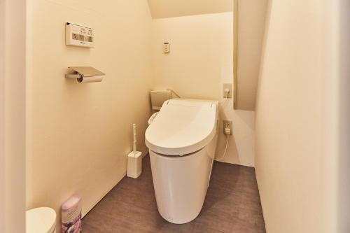 a bathroom with a toilet in a small room at Tora Hotel Asakusa in Tokyo