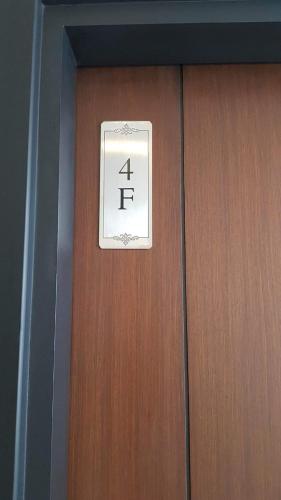 a sign on a door that says four tie at 101 Newport blvd C2 4F by Rechelle Nunag in Manila