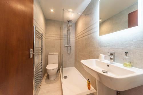 a bathroom with a sink and a shower and a toilet at Tinto Hotel in Symington