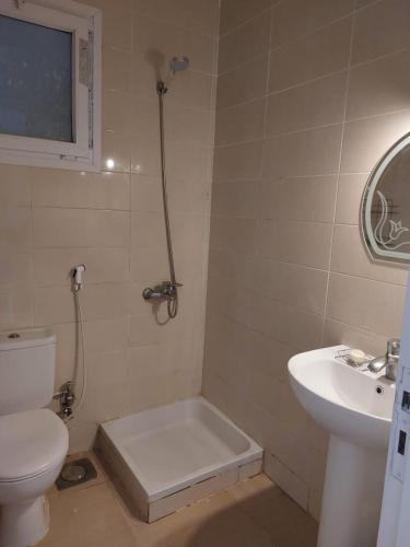 a bathroom with a toilet and a sink at Mousa Cost Resort عائلات فقط in Ras Sedr