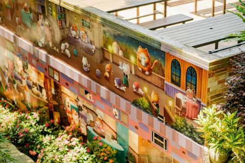 a mural of animals on the side of a building at 南庄橄欖樹咖啡民宿 Olive Tree Village Guesthouse in Nanzhuang