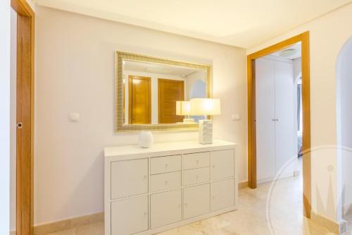 a bathroom with a white dresser and a mirror at La Manga Club Resort - Buena Vista 596 in Atamaría