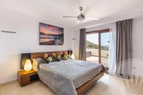 a bedroom with a bed and a large window at La Manga Club Resort - Buena Vista 596 in Atamaría