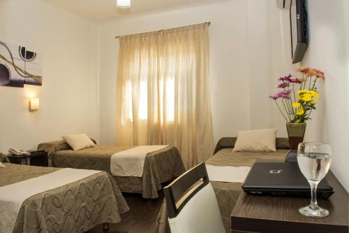 Кровать или кровати в номере Toscano Hotel