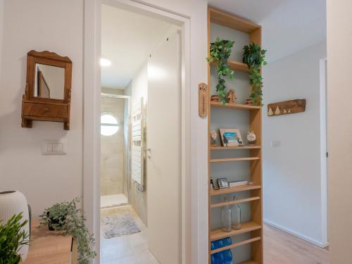 a bathroom with a walk in shower next to a door at New flat in Bormio - Centrale 69 in Piatta