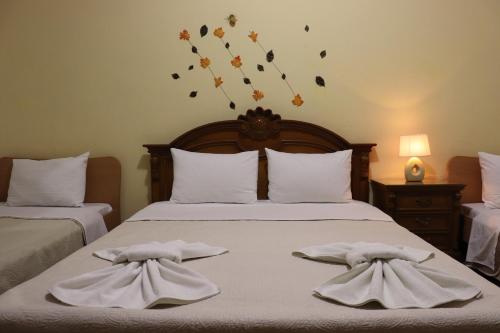 a bedroom with two beds with towels on them at Kotza Ntere in Axioúpolis