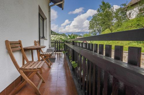 a balcony with a wooden bench and a fence at Holiday House Radovna Bled in Zgornje Gorje