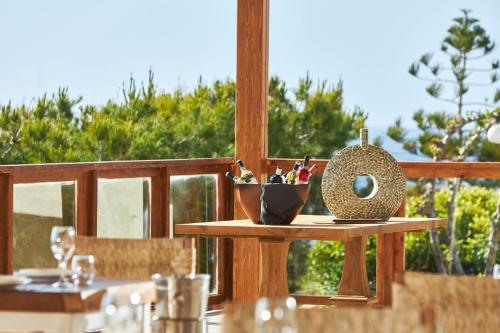 a table with a bowl of pens on it on a balcony at Vasia Sea Retreat in Sissi