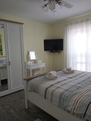 a bedroom with a bed with two towels on it at Apartment Žuna in Senj