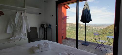 a bedroom with a bed and a large glass window at Mas des Buscades in Cabris