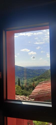 a view from a window of a mountain view at Mas des Buscades in Cabris