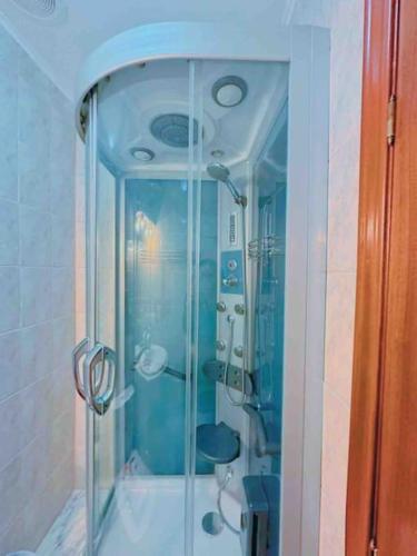 a shower with a glass door in a bathroom at La Maresía in Cudillero