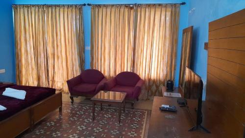 a living room with a bed and a couch and a television at Mayem Lake View in Maem
