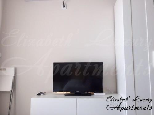 a television sitting on top of a white cabinet at Beachfront Luxury Apartments Elizabeth, Pomorie in Pomorie