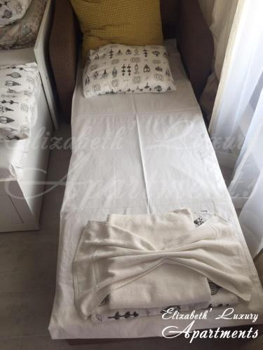 two beds in a room with white sheets and pillows at Beachfront Luxury Apartments Elizabeth, Pomorie in Pomorie
