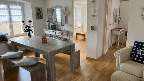 ein Wohnzimmer mit einem Holztisch und einem Sofa in der Unterkunft Home Sweet Home by Stay Swiss in Courtedoux
