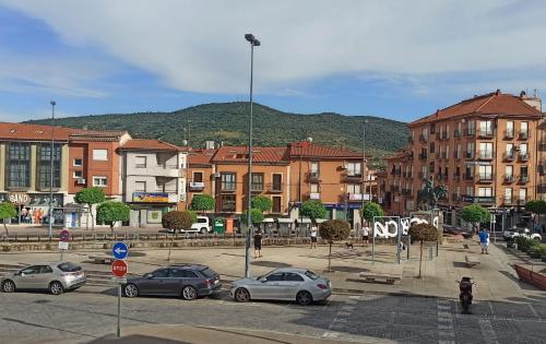 a city with cars parked in a parking lot at Puerta del Sol - Plasencia in Plasencia