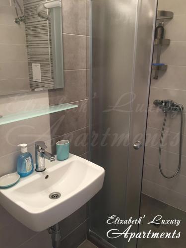 a bathroom with a sink and a shower at Beachfront Luxury Apartments Elizabeth, Pomorie in Pomorie