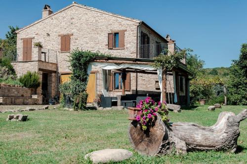 a house with a chicken statue in front of it at L'Aurora B&B - Rural Villa With Private Pool & Panoramic View Near Montelparo in Montelparo