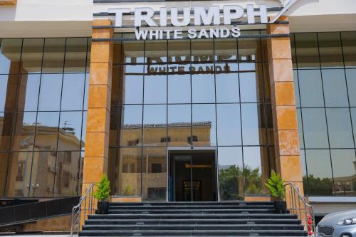 a front view of a white sands office building at Triumph White Sands Hotel in Marsa Matruh