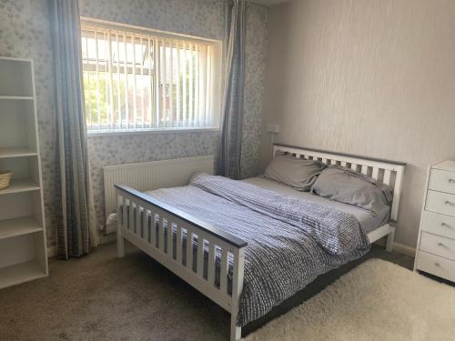 a bedroom with a white bed and a window at Cosy Room in Bristol in Bristol