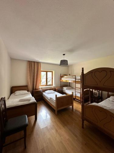 a bedroom with three bunk beds and a window at Hostel in Valbonë