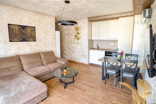 a living room with a couch and a table at Apartmani Nikic -Tivat in Tivat