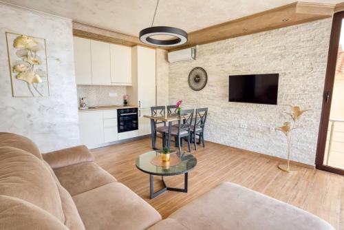 a living room with a couch and a table at Apartmani Nikic -Tivat in Tivat
