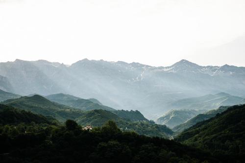 a view of a mountain valley with trees and mountains at Gefiri Plakas Hotel, Tzoumerka in Plaka
