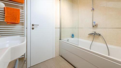 a bathroom with a bath tub and a sink at Top Hill Premium Apartment in Dubrovnik