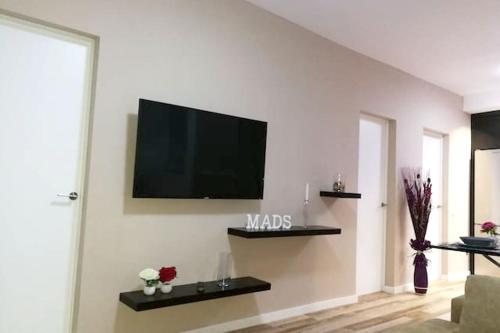 a living room with a flat screen tv on the wall at 3 bedrooms apartement with wifi at Las Palmas de Gran Canaria in Las Palmas de Gran Canaria