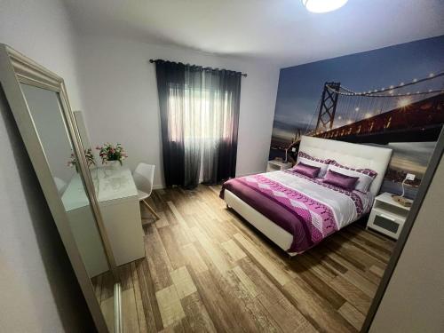 a bedroom with a bed with a bridge on the wall at 3 bedrooms apartement with wifi at Las Palmas de Gran Canaria in Las Palmas de Gran Canaria