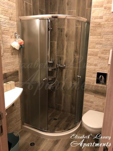 a shower stall in a bathroom with a toilet at Beachfront Luxury Apartments Elizabeth, Pomorie in Pomorie