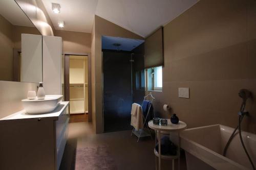 a bathroom with a sink and a bath tub at Luxury villa Lara with private pool in Banjole