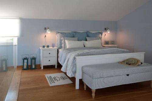 a bedroom with a white bed and a white table at Luxury villa Lara with private pool in Banjole