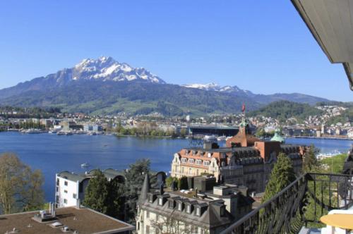 a view of a city with a mountain in the background at Hotel Royal Luzern in Luzern