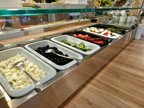 a buffet line with several trays of food at Medos Hotel in Budapest