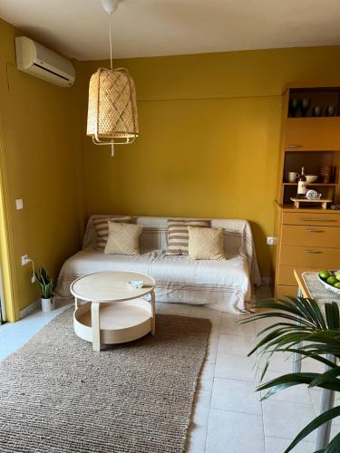 a living room with a bed and a table at Costal apartment in Glyfada