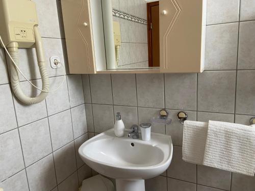 a bathroom with a sink and a mirror at Giorgio Funtana in Funtana