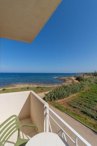 a balcony with a view of the ocean at Artina in Marathopolis