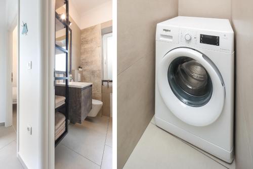a laundry room with a washing machine and a bathroom at APARTMAN BORGO MARINA - by the sea in Rijeka