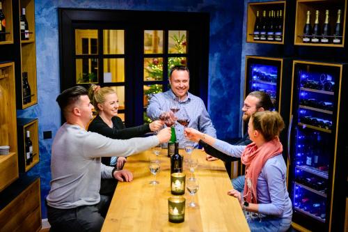 a group of people standing around a table with wine glasses at Best Western Wein- und Parkhotel in Nierstein